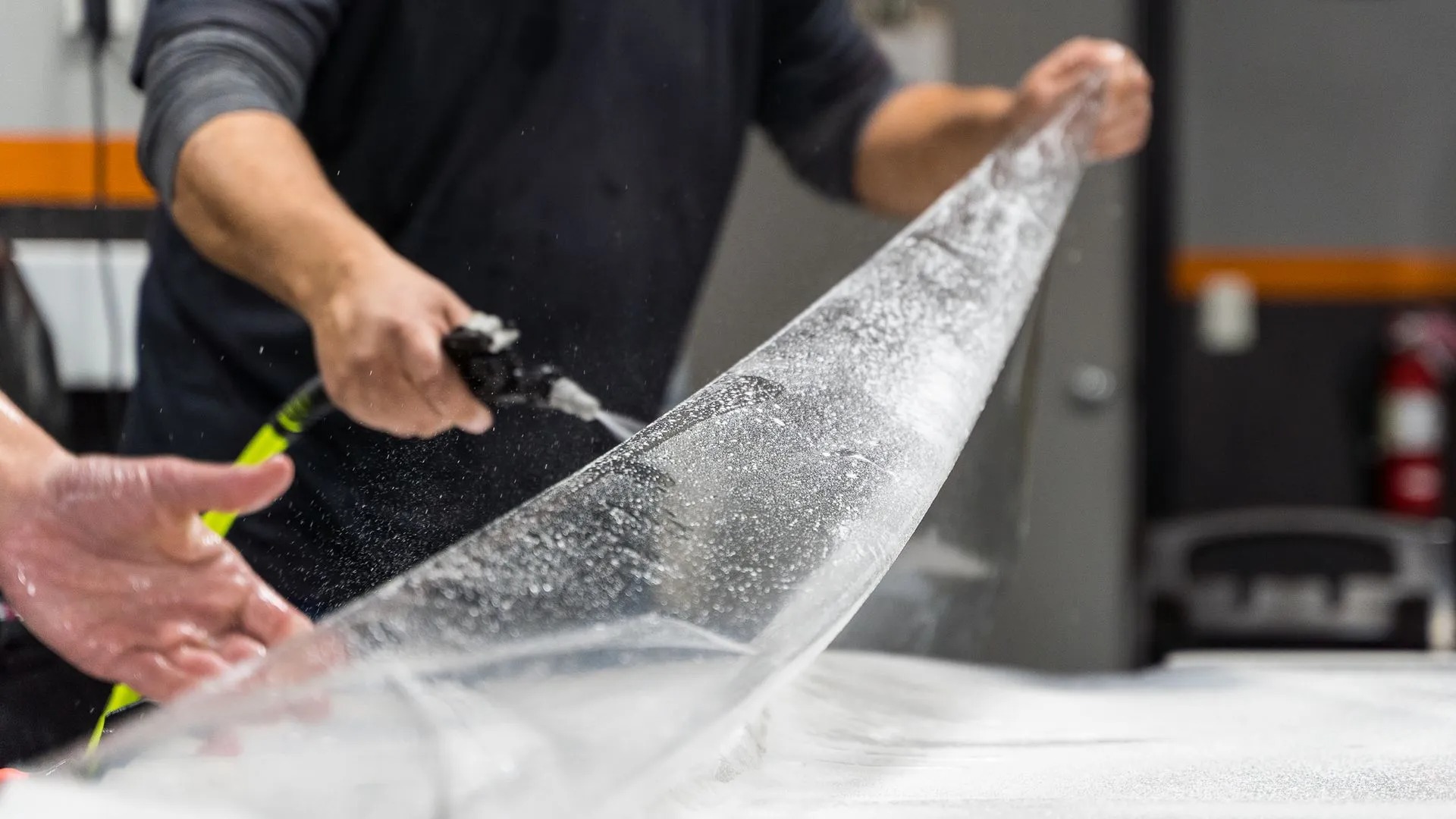 Paint Protection Film in Orlando, FL · vehicle hood installation with squeegee · gallery page